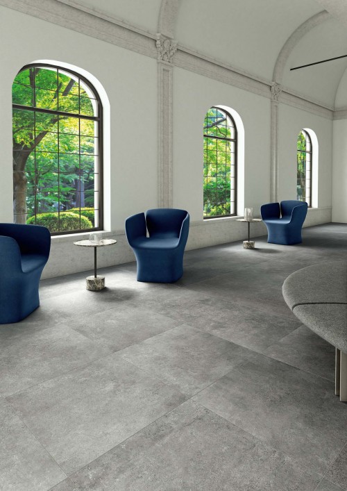 Step In Porcelain tile in Grigio - Studio space with blue chairs.