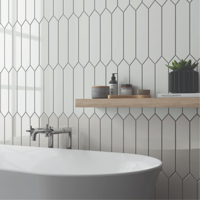 Picket shaped wall tile in white and grey with wooden all shelf over a free standing tub
