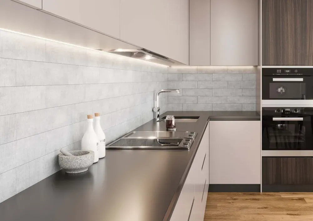 Contemporary kitchen featuring Tapestry Perla light grey textured subway-style wall tile as a full kitchen backsplash under under-cabinet LED strip lighting.