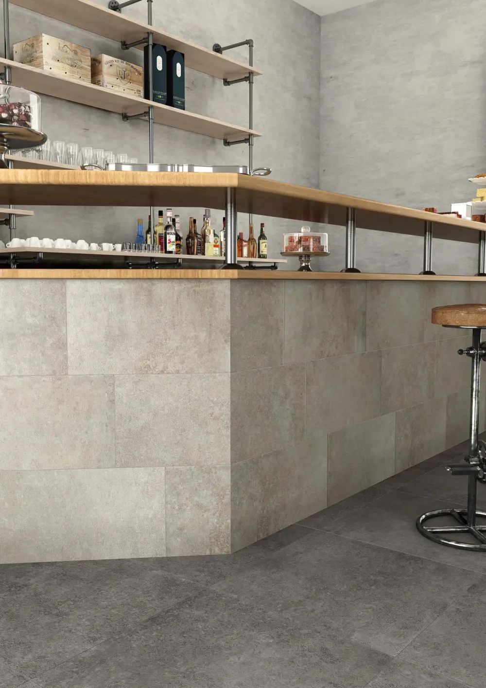 Modern commercial bar interior showcasing Step In Dark large-format concrete-look porcelain floor tiles and contrasting stone-look tile bar facade.