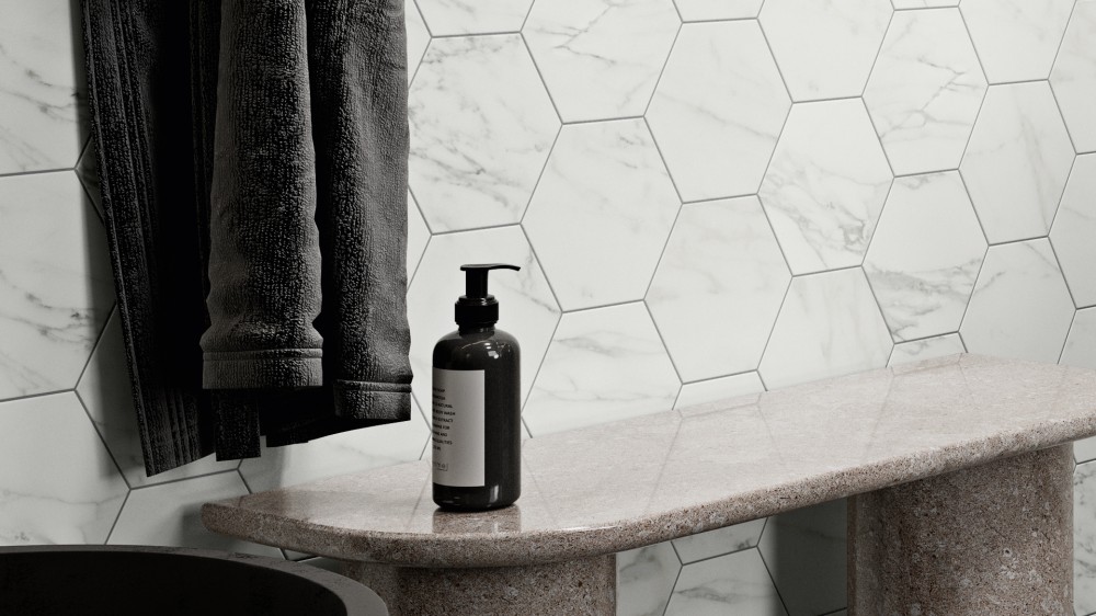 Cosimo hexagon tile in white on the wall with a bench, robe and soap dispenser