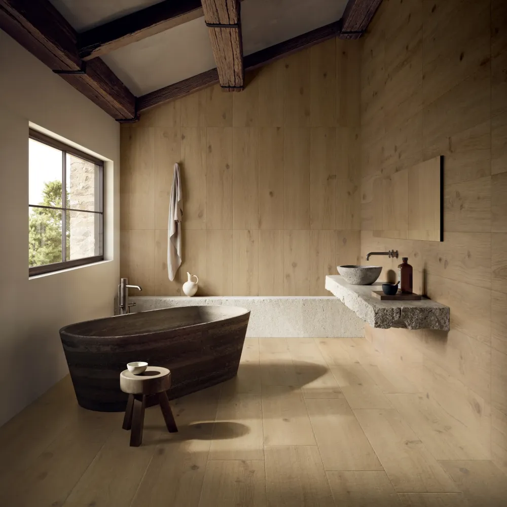 Luxury primary bathroom wrapped entirely in Oak Lane Frassino Massello warm wood-look porcelain tile planks on both the floors and feature walls.