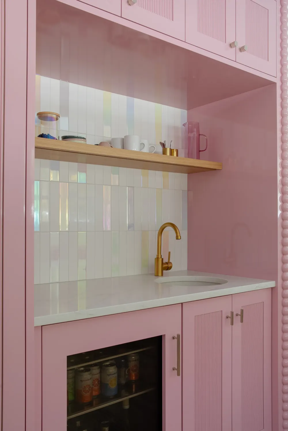 Pink wet Bar with multicolor tone tile and a white countertop shown in a real tile project.