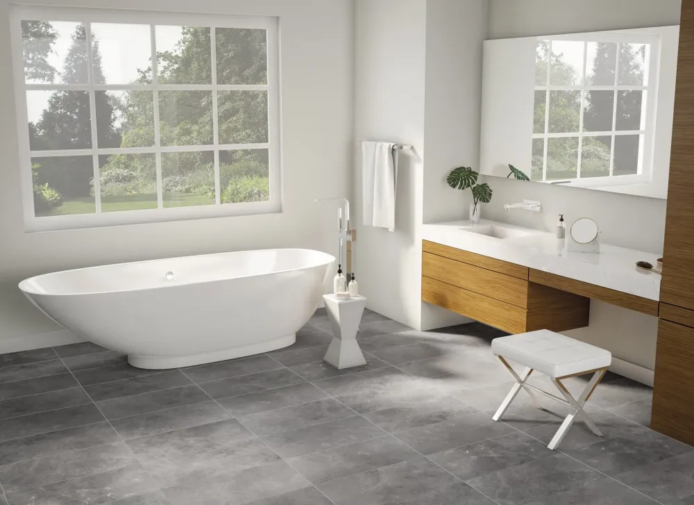 Luxury primary bathroom showcasing St.Croix Ash medium grey slate-look porcelain floor tiles under a freestanding soaking tub.