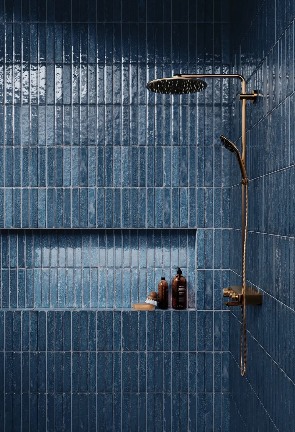 Walk-in shower featuring Organic Clay Oceanic glossy deep blue slim subway tiles in a vertically stacked installation with a built-in niche.