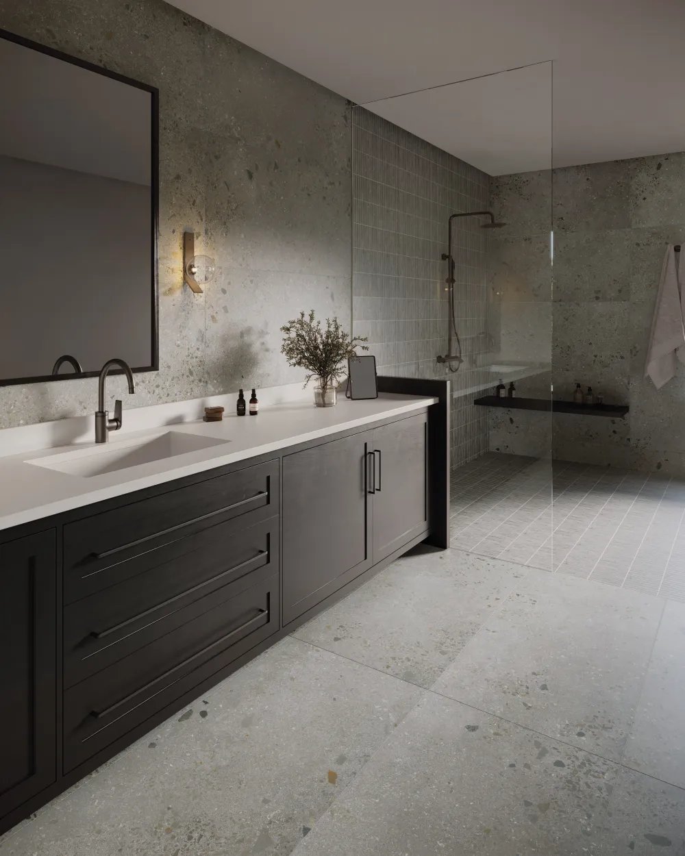 Modern bathroom floor and wall clad in Lab Ash 24x48 aggregate stone porcelain tile with a walk-in shower lined with 1x6 stripe mosaic tile.