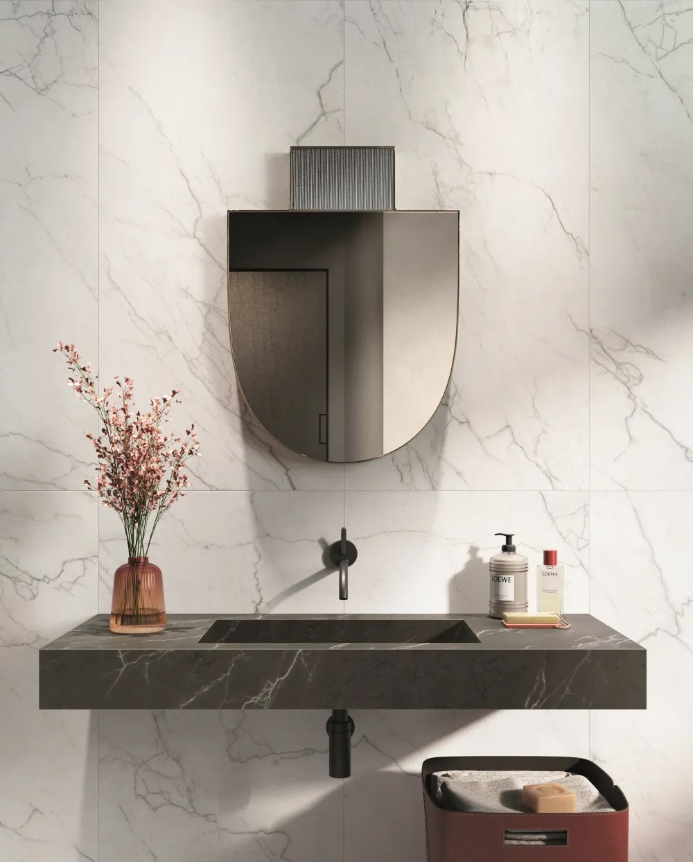 Modern bathroom vanity design with white marble-look porcelain wall tile, a floating dark charcoal marble-look sink, and matte black fixtures.