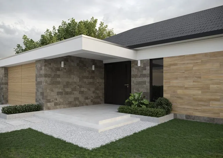 Modern home exterior with Saltstone Grafit stone-look wall tile and warm wood-look exterior cladding.
