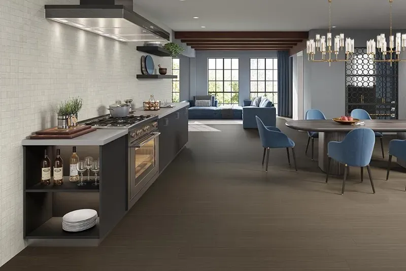Modern open-concept home showing Style Rich large-format dark brown porcelain floor tile and a full-height textured neutral kitchen wall backsplash.
