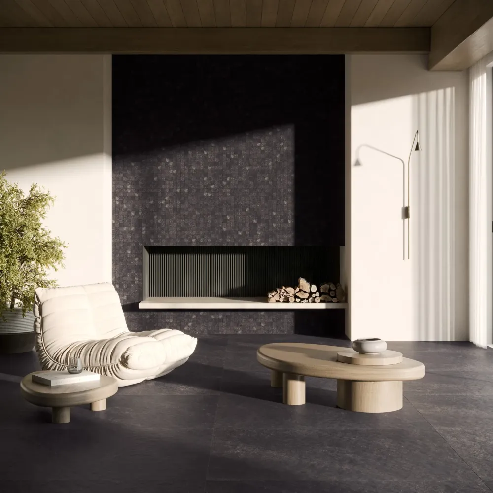 Modern living room showcasing Thera Charcoal large-format floor tiles and a full-height fireplace surround in coordinating textured mosaic tile.