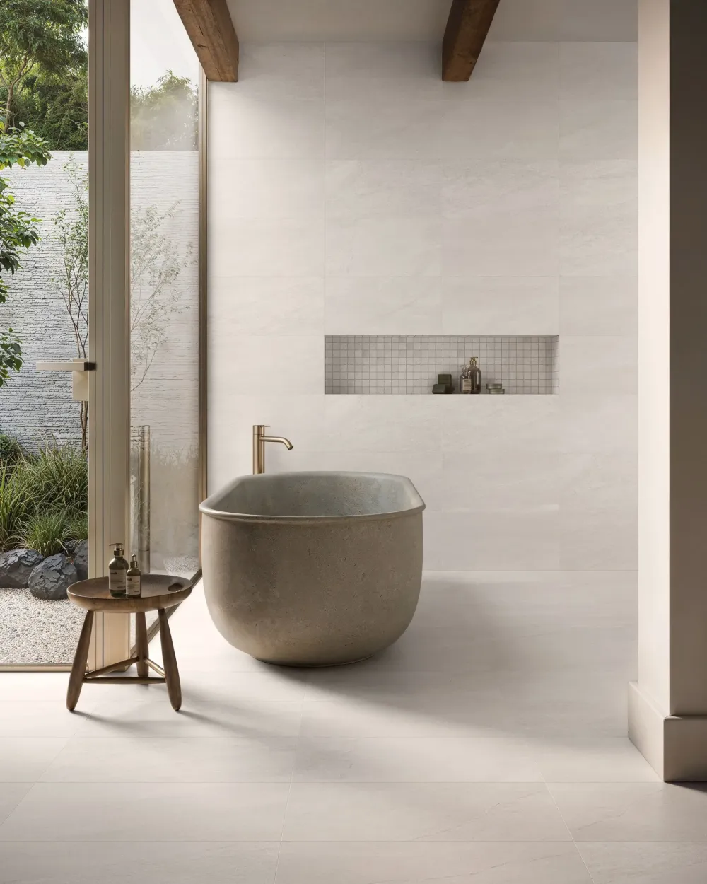 Luxury primary bathroom wet room featuring Thera Cloud Natural off-white stone-look floor and wall tiles with a built-in mosaic tile niche.