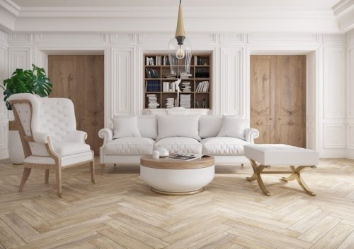 Living room with a light wood look floors in a herringbone pattern.