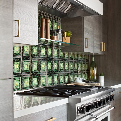 Green decorative tile backsplash behind stove in kitchen | Tile America